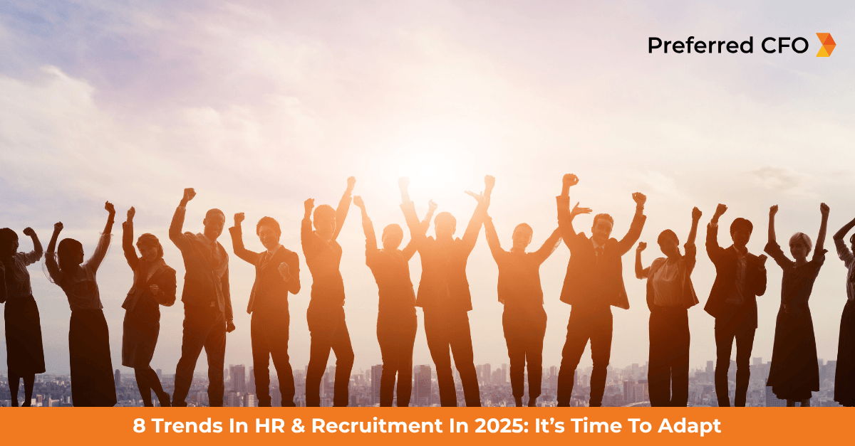 A team of employees with the sun setting behind them with their arms raised and backlit from Preferred CFO HR outsourcing